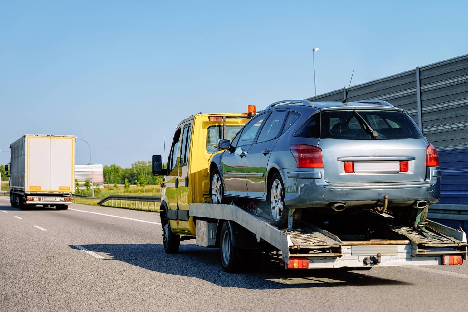 tow-truck-transporter-carrying-car-road-slovenia